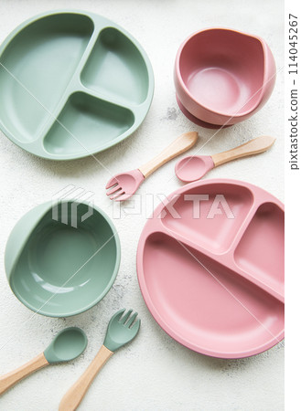 Collection of reusable colorful plastic dishes and bowls 114045267