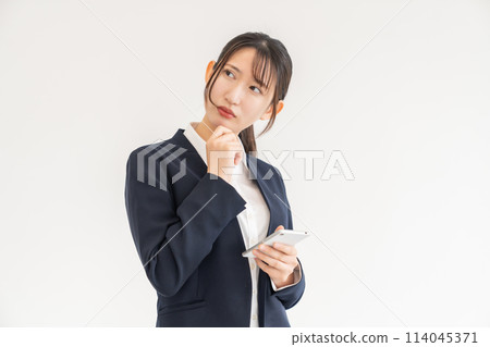 Looking at smart phones Female business thinking 114045371