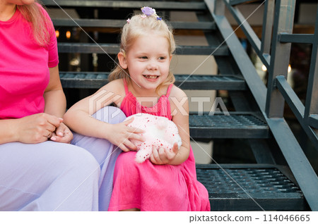 Funny baby with cochlear implant walks outdoor. Hearing aid and medicine innovating technology concept. Diversity and Inclusion and people with disability concept. 114046665
