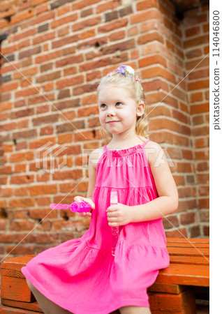 Child girl walks and have fun outdoor with cochlear implant on the head. Hearing aid and treatment concept. Inclusion and disability. Child girl walks and have fun outdoor with cochlear implant on the head. Hearing aid and treatment concept. Inclusion and disability. 114046800