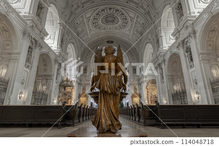 Behind an Archangel statue standing inside of St. Michael's Church. 114048718