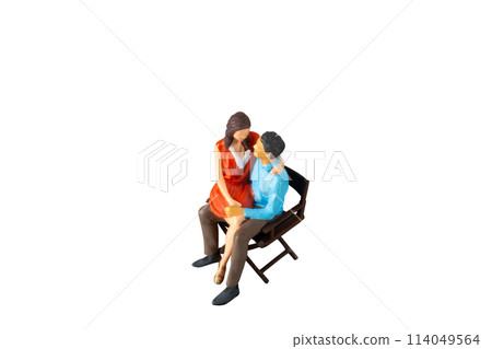 Miniature people , young man and woman sit together on chair Isolated on white background with clipping path Miniature people , young man and woman sit together on chair Isolated on white background with clipping path 114049564