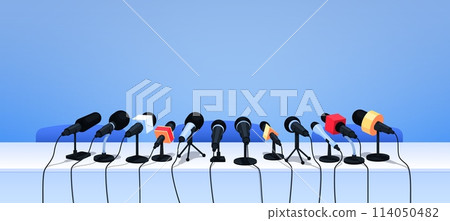 Press conference microphones on table. Cartoon vector background with professional equipment for interview, speech, mass media event, news, report, presentation, broadcasting, journalism or politics Press conference microphones on table. Cartoon vector background with professional equipment for interview, speech, mass media event, news, report, presentation, broadcasting, journalism or politics 114050482
