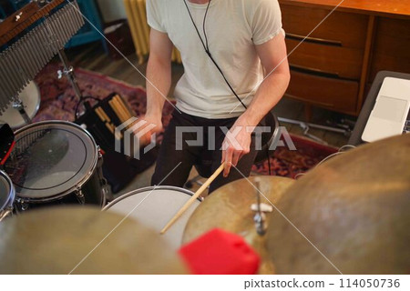 High angle closeup of young male drummer playing in home studio 114050736