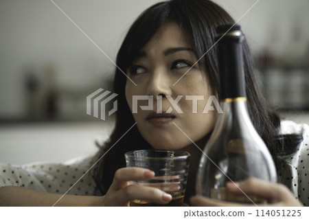 Middle-aged woman getting drunk Middle-aged woman getting drunk 114051225