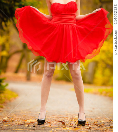 Fashion woman red dress relaxing walking in park 114052128