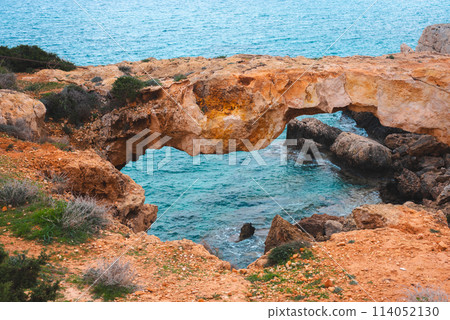 Stone arch and sea cave near Cape Greco in Ayia Napa and Protaras on the island of Cyprus, Mediterranean Sea. 114052130