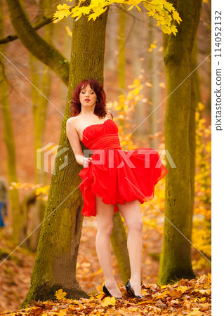 Fashion woman red dress relaxing walking in park Fashion woman red dress relaxing walking in park 114052132