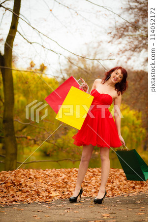 autumn shopper woman with sale bags outdoor in park autumn shopper woman with sale bags outdoor in park 114052172