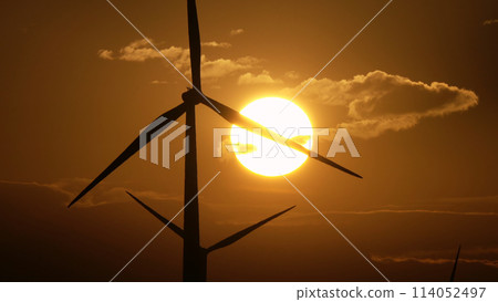 Windmills or wind turbine in sunrise light Windmills or wind turbine in sunrise light 114052497