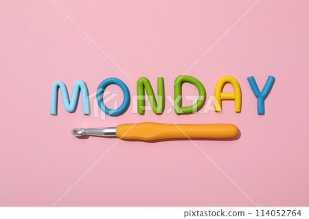 The word "Monday" is made of colored plasticine, laid out on a pink background. 114052764