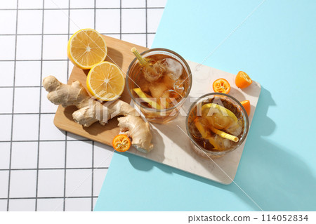 Cold tea with ice, orange slices and mint leaves and ginger Cold tea with ice, orange slices and mint leaves and ginger 114052834