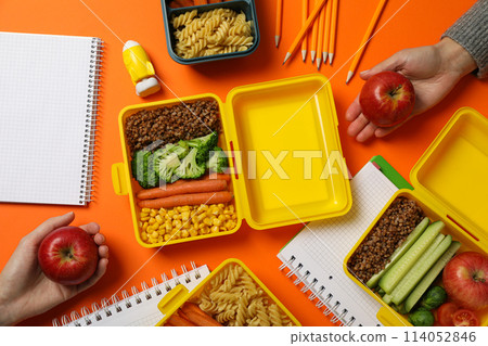 Yellow lunch box with delicious food and school supplies Yellow lunch box with delicious food and school supplies 114052846
