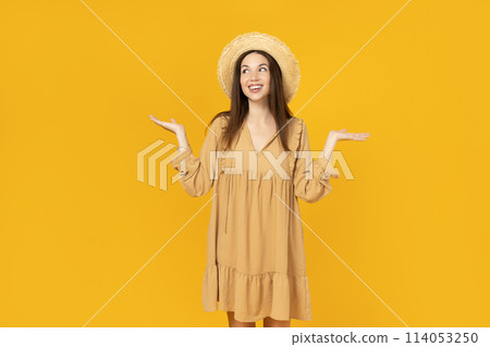 Happy young woman in a hat on yellow background, space for text Happy young woman in a hat on yellow background, space for text 114053250