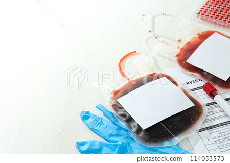 Bags and test tube with donor blood, document on light background, space for text 114053573