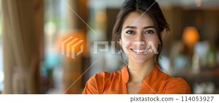 The receptionist stood with a sincere, confident smile in front of the hotel. It is the first thing that creates an impression on guests staying at this hotel which is the first basis of service work. 114053927