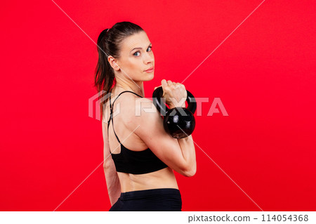 Sport, active lifestyle concept. Smiling strong and slim fitness female athlete holding kettlebell Sport, active lifestyle concept. Smiling strong and slim fitness female athlete holding kettlebell 114054368
