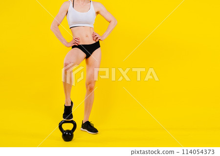 Sport, active lifestyle concept. Smiling strong and slim fitness female athlete holding kettlebell Sport, active lifestyle concept. Smiling strong and slim fitness female athlete holding kettlebell 114054373