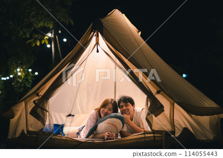 asian couple relax in camping tent on summer vacation 114055443
