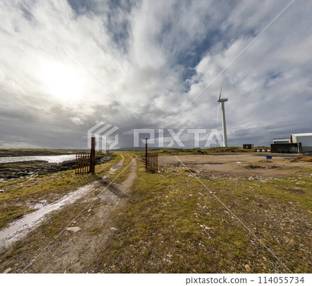A Wind turbine is generating in Burtonport harbour, Countz Donegal, Ireland 114055734