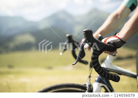 Close up of cyclist hands on handlebars, steering bike. Concept of healthy lifestyle. 114056079