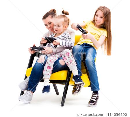 Mom and daughters spending time on computer games on playing console, using joystick 114056290