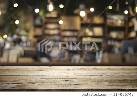 Empty wooden table for present product on coffee shop blur background. Empty wooden table for present product on coffee shop blur background. 114056742