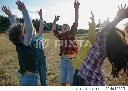 Portrait of young classmates, students during biology field teaching class, successful experiment, hands in air. Learning about ecosystem, ecology. Portrait of young classmates, students during biology field teaching class, successful experiment, hands in air. Learning about ecosystem, ecology. 114056825