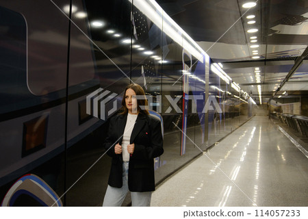 Beautiful lonely girl in black posing in the subway. Beautiful lonely girl in black posing in the subway. 114057233