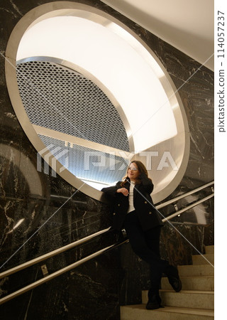 Beautiful lonely girl in black posing in the subway. Beautiful lonely girl in black posing in the subway. 114057237