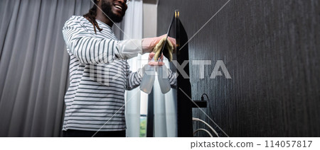 African American is cleaning house doing housework cleaning television with rag African American is cleaning house doing housework cleaning television with rag 114057817
