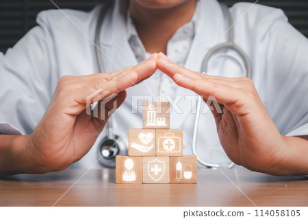 Medical care concept, Doctor hand holding wooden block on desk with medical care icon on virtual screen. 114058105