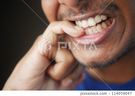 young men biting his nails at home, young men biting his nails at home, 114059047