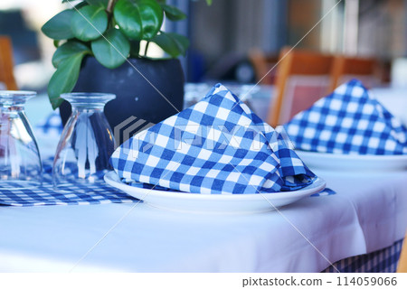 served and decorated round festive table in a restaurant served and decorated round festive table in a restaurant 114059066
