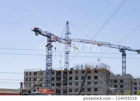 Construction cranes for the construction of a new residential building 114059319
