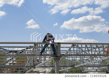 man welds at the factory 114059326