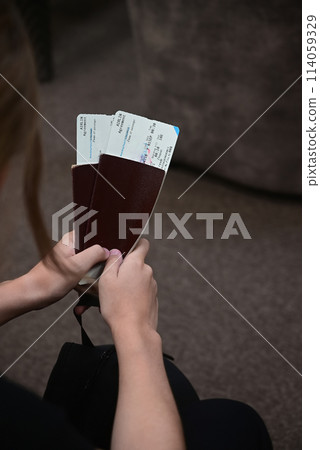Closing a person with passports and boarding pass at the airport Closing a person with passports and boarding pass at the airport 114059329