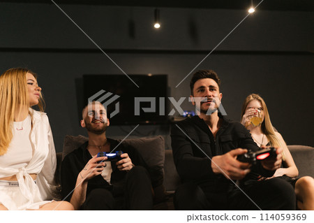 Happy couples delve into virtual combat on console at party 114059369