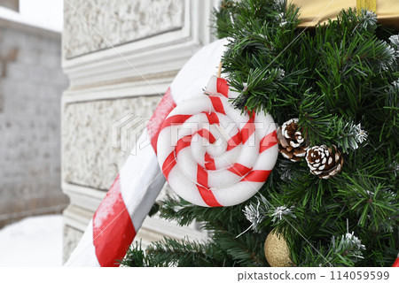 A Christmas tree on the street decorated with Christmas toys. Decoration for New Year and Christmas 114059599