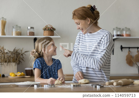 Little beautiful girl cooking with loving young mother 114059713