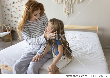 Happy woman spend time with lovely little daughter in bedroom Happy woman spend time with lovely little daughter in bedroom 114059767