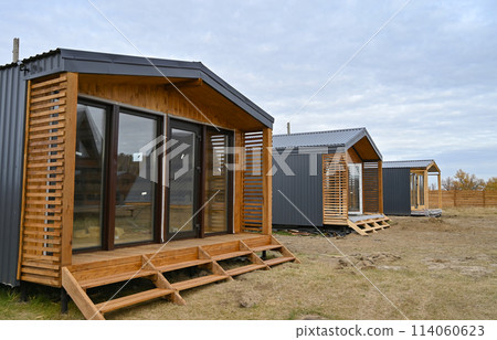 Wooden houses in a triangular summer camp. summer vacation in an eco-friendly house, summer Wooden houses in a triangular summer camp. summer vacation in an eco-friendly house, summer 114060623