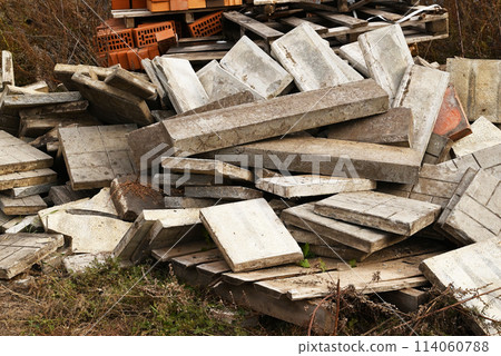 Construction waste. A pile of construction waste. Building rubble and stones. Abandoned garbage, junk, garbage piled up near the building. Street scene. Recycling industry. Ecology. Not Ecology. 114060788