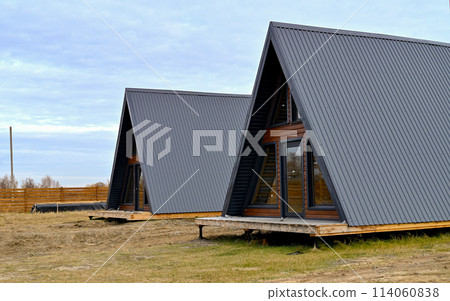 Wooden houses in a triangular summer camp. summer vacation in an eco-friendly house, summer 114060838