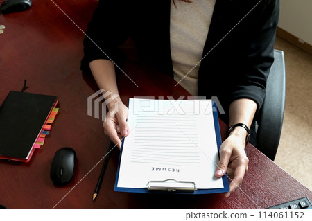 A close-up of employers or recruiters considering candidates' resumes, interviews, the concept of employment and recruitment, tips on making a good resume template, applying for a job A close-up of employers or recruiters considering candidates' resumes, interviews, the concept of employment and recruitment, tips on making a good resume template, applying for a job 114061152