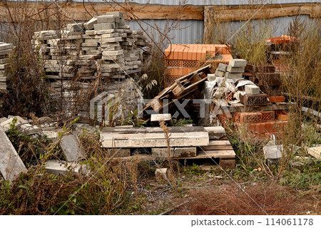 Construction waste. A pile of construction waste. Building rubble and stones. Abandoned garbage, junk, garbage piled up near the building. Street scene. Recycling industry. Ecology. Not Ecology. 114061178