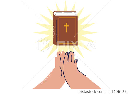 Bible with rays of light near hands of praying man who professes christian religion 114061283