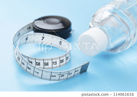 Tape measure on blue background 114061638