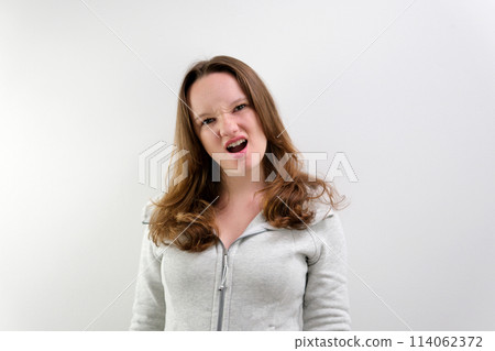 Young caucasian girl screaming into the camera. Slow motion Young caucasian girl screaming into the camera. Slow motion 114062372