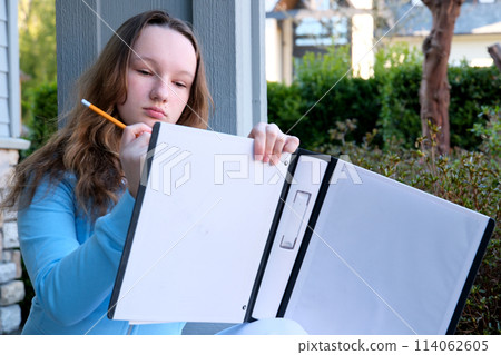 teenage girl draws with a pencil thinks dreams solves the problem do homework at home draw nature think over details design school education excellent student beautiful young lady woman teenage girl draws with a pencil thinks dreams solves the problem do homework at home draw nature think over details design school education excellent student beautiful young lady woman 114062605